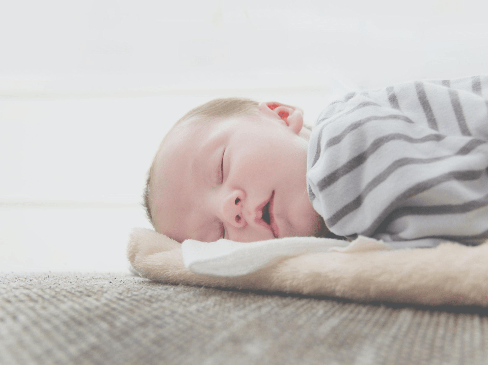 baby laying on clean swaddles