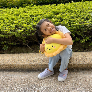 little girl hugging the wee bean egg tart plushie pillow cushion for kids