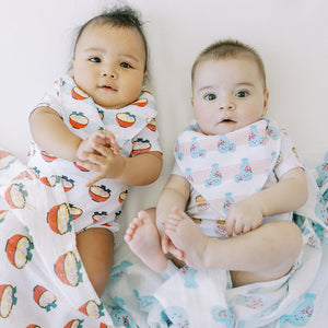 cute babies wearing the wee bean organic cotton bib set in ramen and sake