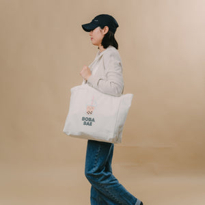 Girl walking with the wee bean's canvas tote bag in Boba Bae