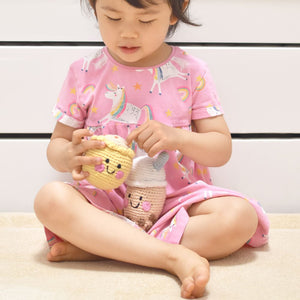 little girl playing with the wee bean fair-trade doll in siu mai dim sum and boba doll