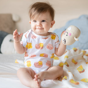 baby playing with the wee bean rattle doll fair-trade dolls pebblechild