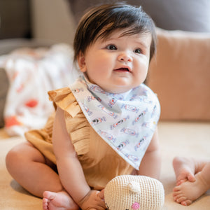 cute baby laughing in the wee bean organic cotton baby bandana bib in rabbit candy