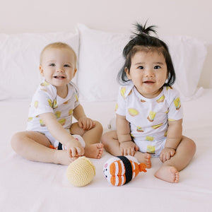 cute babies in mom holding baby in the wee bean organic cotton baby onesie bodysuit in vita lemon tea and egg tart