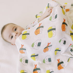 cute baby swaddled in the wee bean fleece blanket milestone blanket in sushi tempura and takoyaki