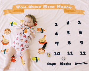 baby on the wee bean fleece blanket milestone blanket growth tracker in sushi tempura and takoyaki print