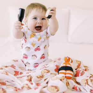 cute baby playing in the wee bean organic cotton onesie bodysuit in takoyaki octopus balls